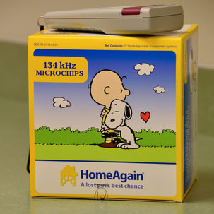 Box of HomeAgain microchips and microchip reader.